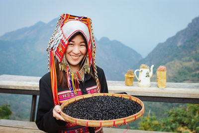 Portrait of smiling woman against mountains