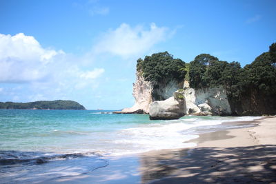 Scenic view of rocks on beach against sky