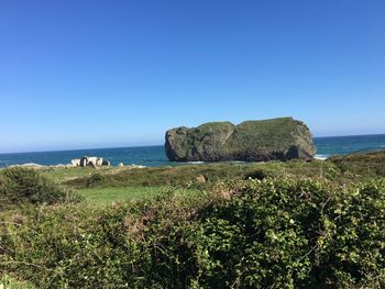 Scenic view of sea against clear blue sky