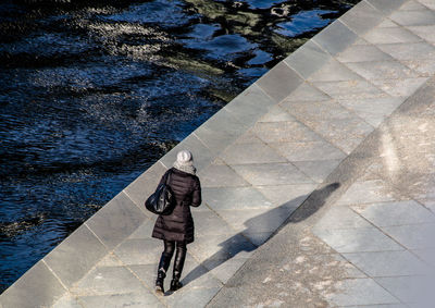 High angle view of woman walking on promenade during winter