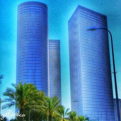 Low angle view of modern building against blue sky