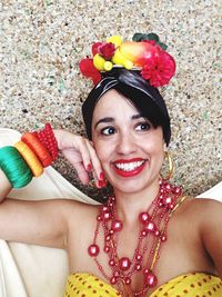 Smiling young woman in costume against wall during carnival