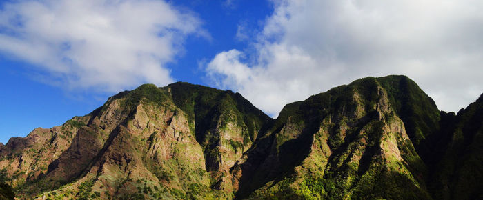 Scenic view of mountains against cloudy sky