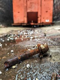 Close-up of rusty metal on footpath