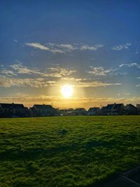 Scenic view of field against sky during sunset