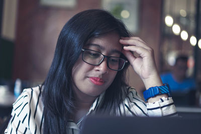 Asian woman working in front of laptop