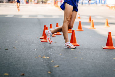 Low section of man skating on road