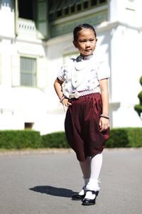 Full length portrait of a teenage girl in city