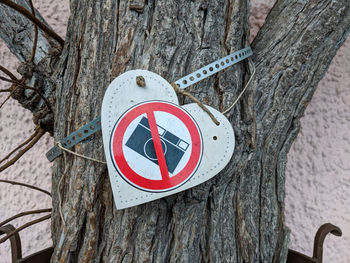 Close-up of sign on tree trunk