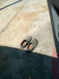 High angle view of shoes on footpath