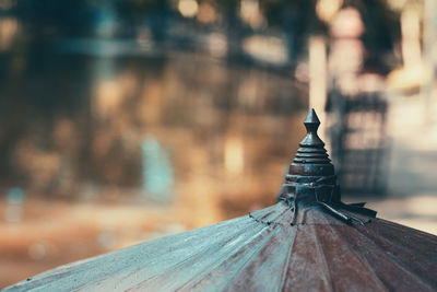 Dark brown paper umbrella on natural light background.