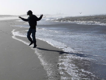 Full length of man standing on beach