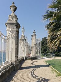 Statue in city against sky