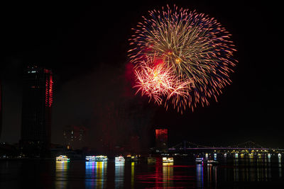 Low angle view of firework display at night