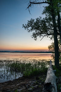 Scenic view of lake against sky during sunset