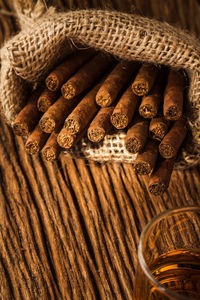 Close-up of cigars in sack on table