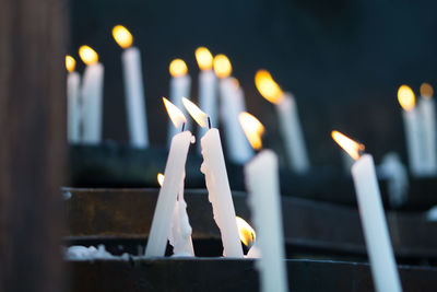 Close-up of lit candles in temple