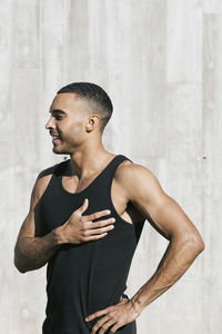 Upper part african american male athlete portrait against wall