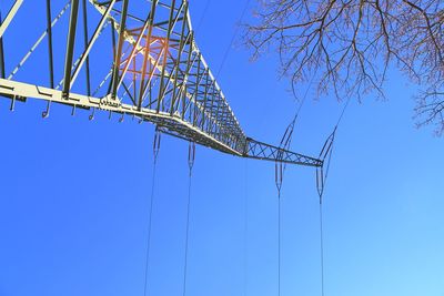 Low angle view of bridge against clear blue sky