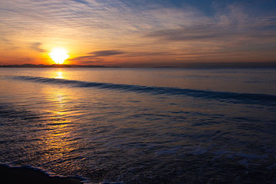 Scenic view of sea against romantic sky at sunset