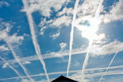 Low angle view of vapor trail against blue sky