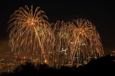 Firework display in city at night