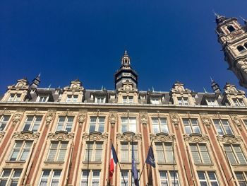 Low angle view of building against blue sky