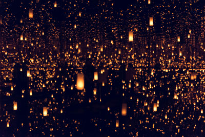 Low angle view of illuminated lanterns at night