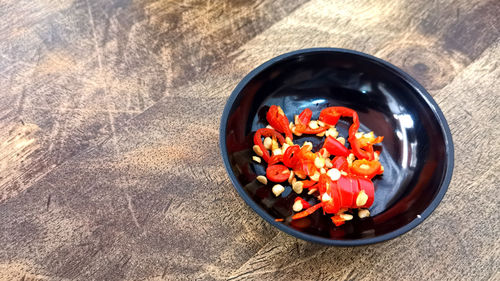 High angle view of chopped fruits in bowl on table