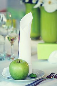 Close-up of granny smith apple in plate on table