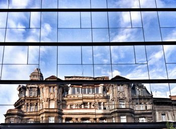 Low angle view of building against cloudy sky