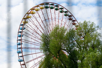 Low angle view of ferris wheel against sky