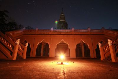 Low angle view of illuminated building against sky at night