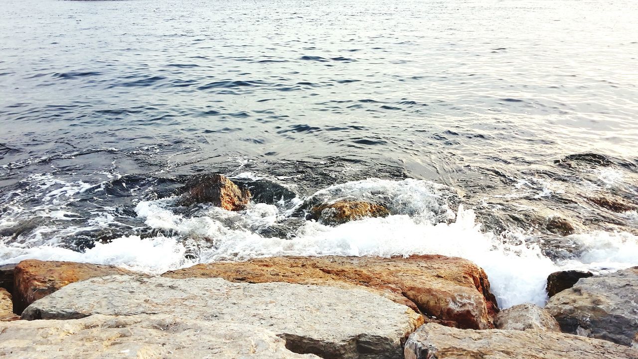 water, nature, high angle view, tranquility, rock - object, beauty in nature, tranquil scene, surf, lake, winter, scenics, shore, cold temperature, river, snow, wave, day, outdoors, beach, motion