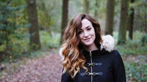 Portrait of a smiling young woman in forest