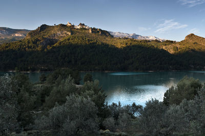 Scenic view of lake and mountains against sky