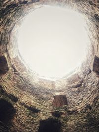 Directly below shot of old tunnel against sky