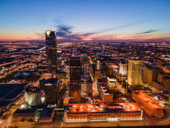 High angle view of illuminated buildings in city at night