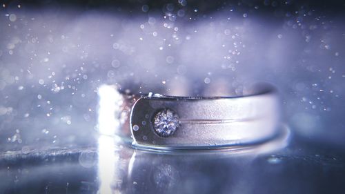 Close-up of water splashing on wedding ring