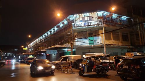 Cars on city street at night