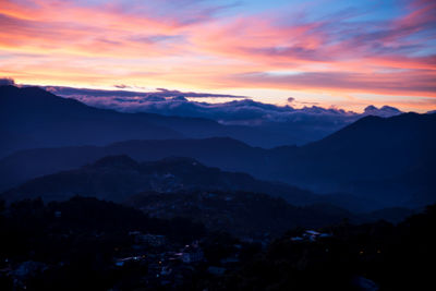 Scenic view of silhouette mountains against sky during sunset