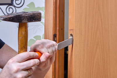 Close-up of man holding door