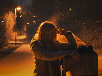 Woman photographing at night