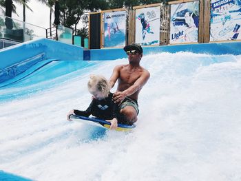 Full length of shirtless man in water