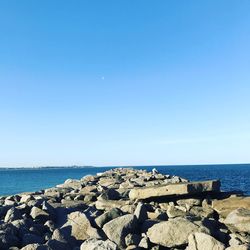 Scenic view of sea against clear blue sky