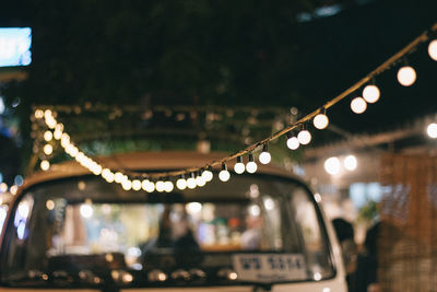 Defocused image of illuminated bridge in city at night