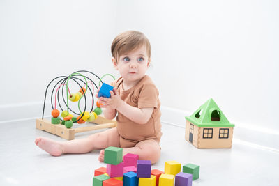 Full length of girl playing with toys at home