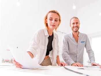 Smiling fashion designers working at boutique