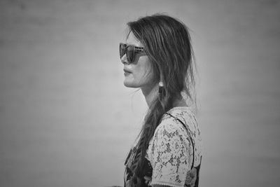 Close-up of woman standing against wall