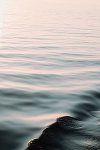 Close-up of sea against sky during sunset